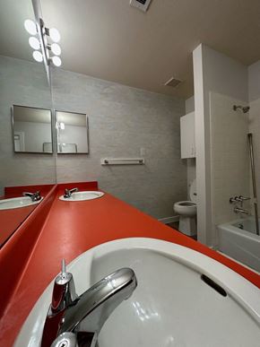 El Campo apartment for rent - A public bathroom with red counter tops and white sinks.