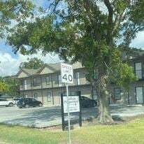 El Campo apartment for rent - a building with a street sign in front of a tree