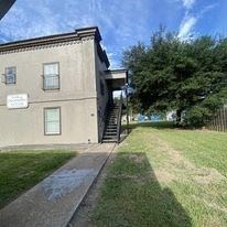 El Campo apartment for rent - the front of a house with a yard and a tree