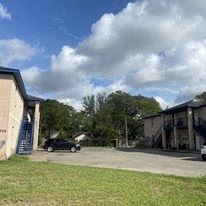 El Campo apartment for rent - a car parked in a parking lot next to a building
