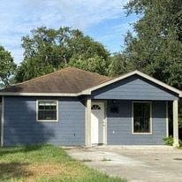 El Campo house for rent - a small blue house with a driveway and trees