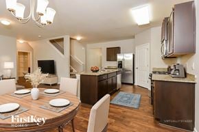 Dallas house for rent - A modern kitchen with a dining table set for four.