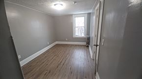 Orlando apartment for rent - A room with wooden floors and a window.