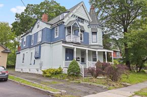 Plainfield apartment for rent - A blue house with white trim and a red door.
