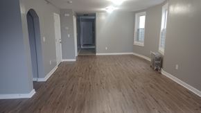 Newark apartment for rent - A room with wooden flooring and white walls.