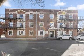 East Orange apartment for rent - A red brick building with a white door and windows.