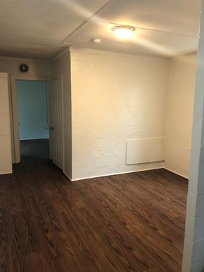 Orlando apartment for rent - A room with a wooden floor and a white wall.
