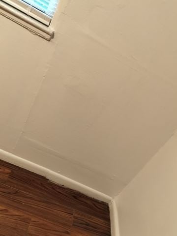 Orlando apartment for rent - A corner of a room with a window and wooden flooring.