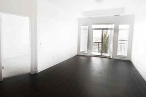 Edmonton apartment for rent - an empty living room with wood floors and a balcony