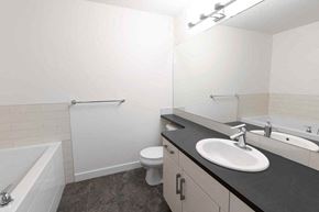 Edmonton apartment for rent - a bathroom with a sink and a toilet and a tub