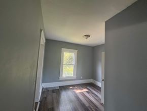 Akron house for rent - A room with a window and wooden floors.