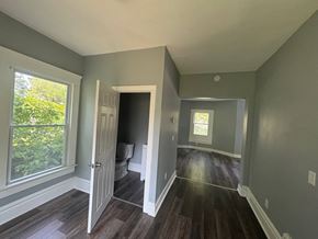 Akron house for rent - A room with a window and a door leading to a bathroom.