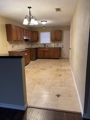 Snyder house for rent - A kitchen with wooden cabinets and a tiled floor.