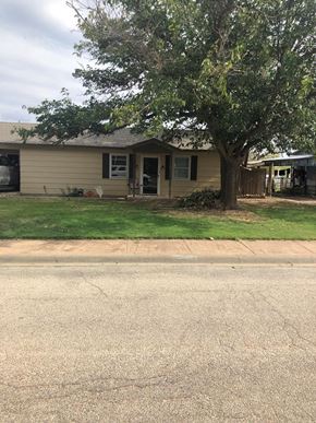 Snyder house for rent - A house with a tree in front of it.