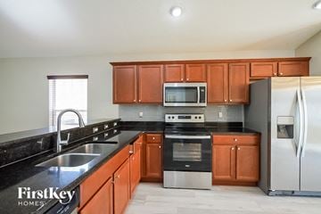 Winter Haven house for rent - a kitchen with wooden cabinets and stainless steel appliances
