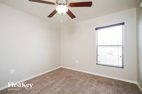 Winter Haven house for rent - a bedroom with a ceiling fan and a window