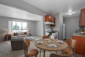 Sterling Heights apartment for rent - A modern kitchen with a dining table set for two.