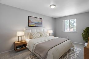Sterling Heights apartment for rent - A bedroom with a bed, nightstand, and a painting on the wall.