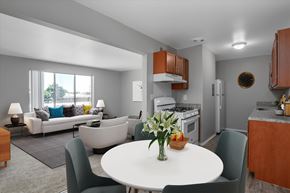 Sterling Heights apartment for rent - A modern kitchen with a dining table set in the middle.