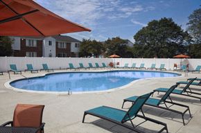 Warren apartment for rent - A pool surrounded by lounge chairs and umbrellas.