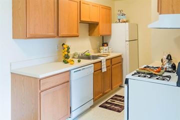 Warren apartment for rent - A kitchen with wooden cabinets and white appliances.