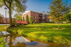 Williamston apartment for rent - A building with a red bridge in front of it.
