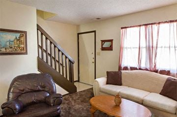 Carthage apartment for rent - a living room with a couch a chair and a table