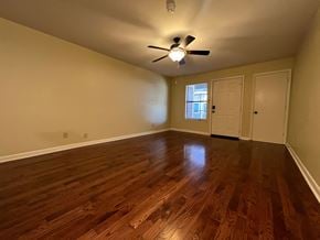 Little Rock apartment for rent - an empty living room with wood floors and a ceiling fan