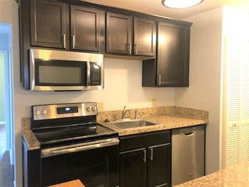 Little Rock apartment for rent - a kitchen with a stove and a sink and a microwave