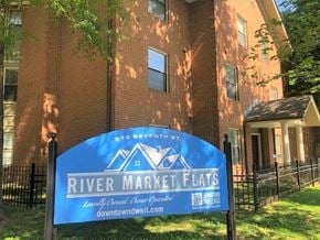 Little Rock apartment for rent - a river market flats sign in front of a brick building