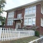 Little Rock apartment for rent - a brick house with a white fence in front of it