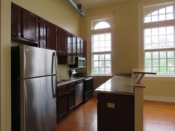 Little Rock apartment for rent - a kitchen with stainless steel appliances and wooden cabinets