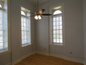 Little Rock apartment for rent - a living room with two windows and a ceiling fan