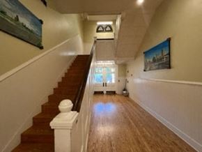 Little Rock apartment for rent - a long hallway with stairs and a painting on the wall