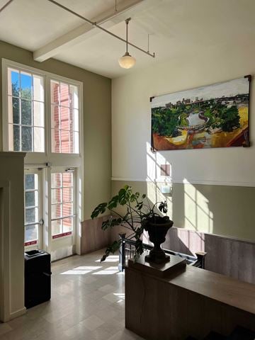 Little Rock apartment for rent - a living room with a large window and a table