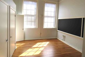 Little Rock apartment for rent - a room with a tv on the wall and a wood floor