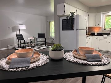 Saline apartment for rent - A modern kitchen with a black table and copper bowls on it.