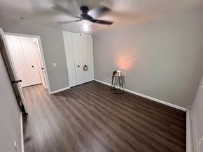 Saline apartment for rent - A room with a ceiling fan and a light fixture.