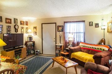 Carthage apartment for rent - a living room with a yellow couch and a television