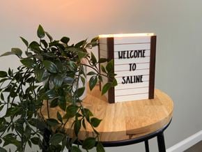 Saline apartment for rent - A sign that says "Welcome to Saline" is on a table with a plant.