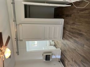 Abilene apartment for rent - A white bathroom with a window and a fan.