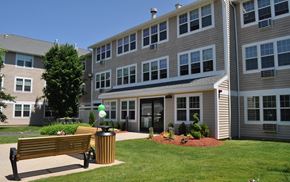 Torrington apartment for rent - a bench in front of an apartment building