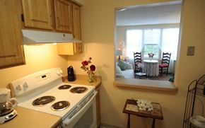 Torrington apartment for rent - a kitchen with a stove and a window     and a dining room