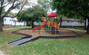 Hagerstown apartment for rent - a childrens playground with a slide in a park