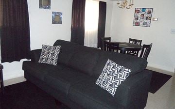 Hagerstown apartment for rent - a black couch in a living room with black and white pillows