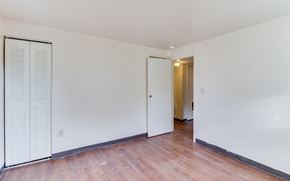 Washington apartment for rent - the living room of a house with white walls and a wood floor