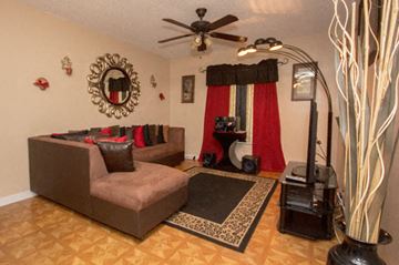 Miami apartment for rent - a living room with a couch and a ceiling fan