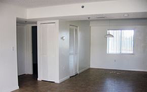 Homestead apartment for rent - an empty living room with white walls and a window
