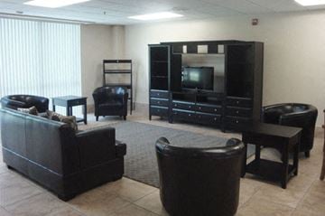 Miami apartment for rent - a living room with leather furniture and a television
