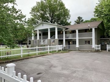 Little Rock apartment for rent - a white house with a white fence and a driveway